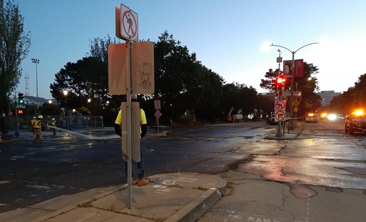 Photo of crews cleaning up at the intersection of Geary and Steiner after removing the bridge