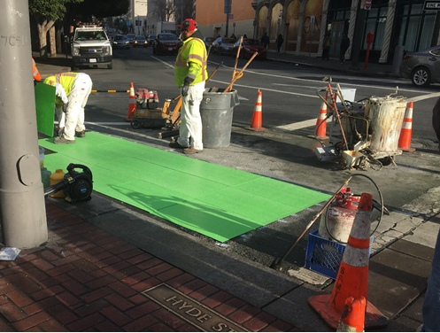 A new khaki-colored “painted safety zone” recently added at Drumm and Market will reduce conflicts and shrink street crossing distances for people walking. 