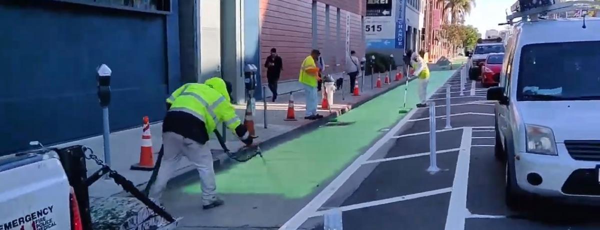 crews painting the green bike paths