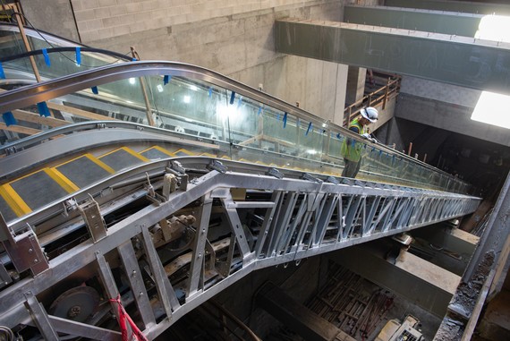 Worker pausing on escalator in Rose Pak Chinatown Station