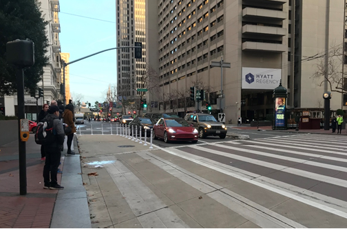 A new khaki-colored “painted safety zone” recently added at Drumm and Market will reduce conflicts and shrink street crossing distances for people walking. 