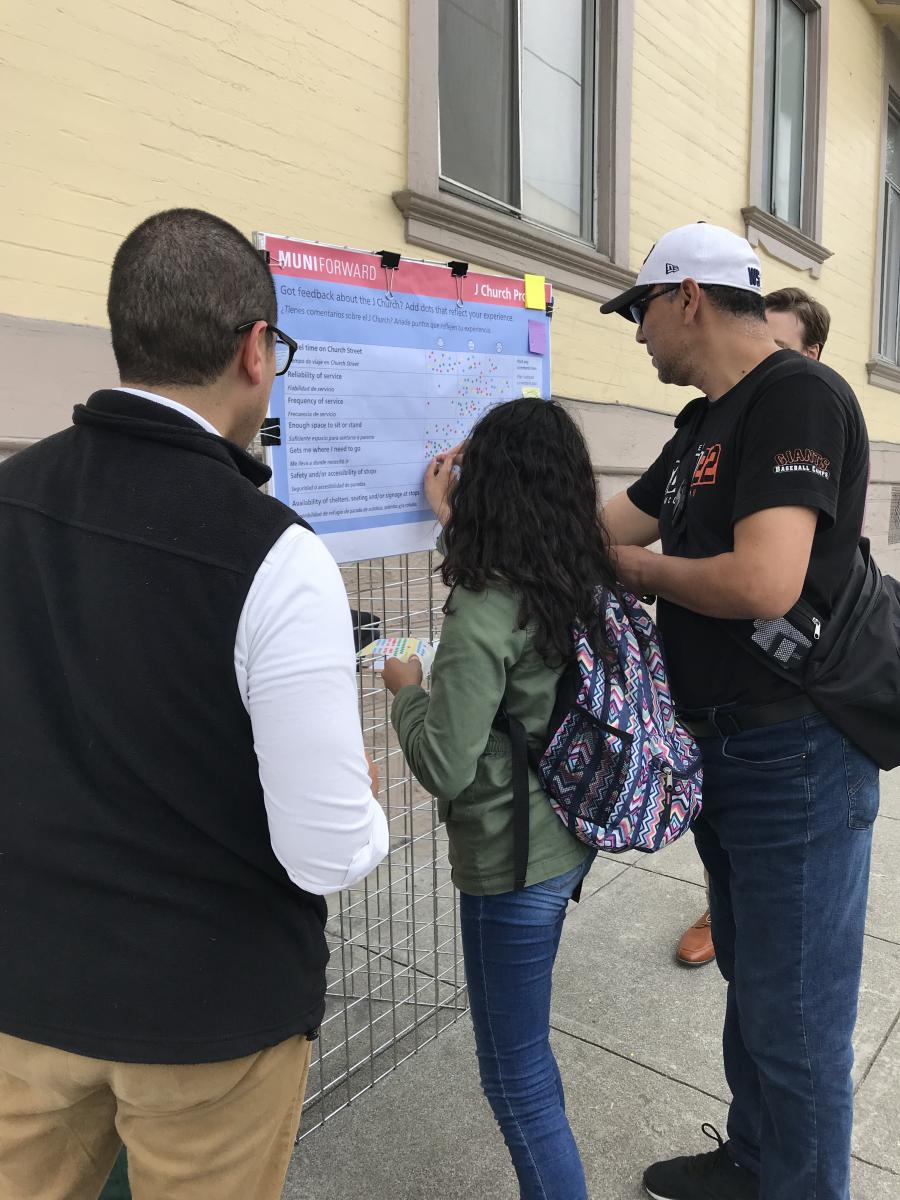 Community members provide project feedback at an outdoor kiosk