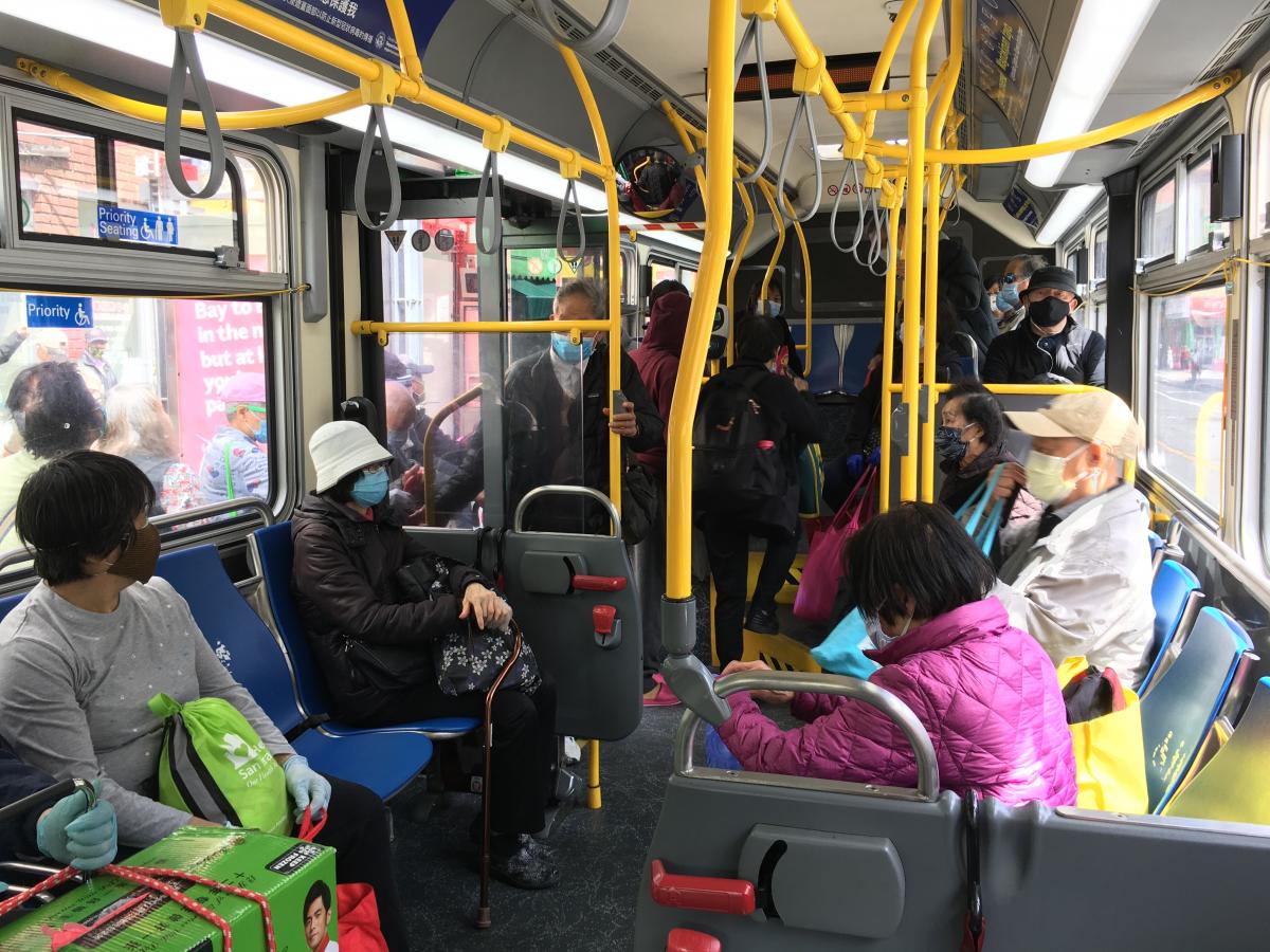Passengers with masks inside a Muni bus
