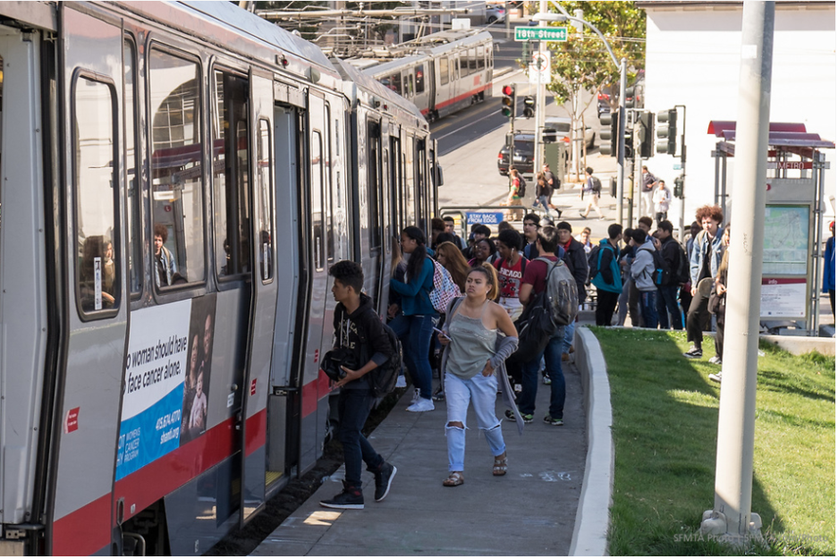 Photo of San Francisco youth lining up to board a Muni vehicle