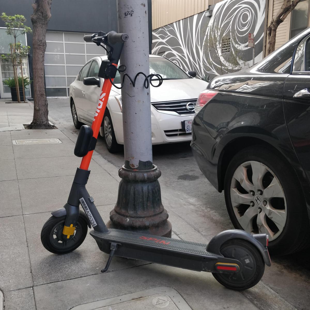 A Spin scooter parked with a lock-to device.