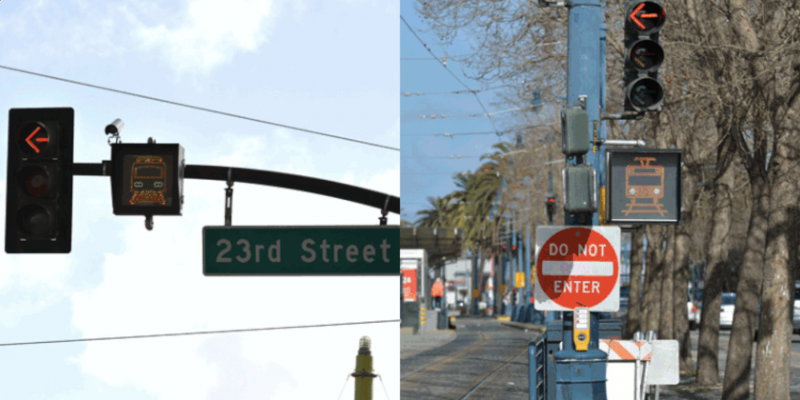  A traffic signal featuring a flashing, filled-in image of a train on tracks attached to a pole beneath a left turn traffic signal and above a "Do Not Enter" sign.