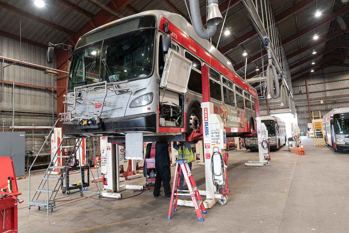 Bus on lift for inspection at 1399 Marin facility
