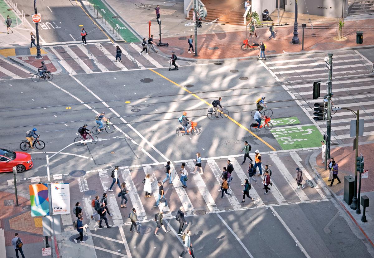 Image of intersection of Van Ness and Market Streets with people biking, walking and scooting