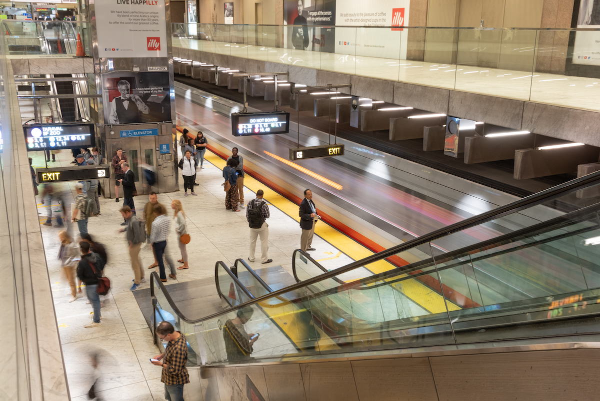 view of platform with people and trains at Embarcadero Station