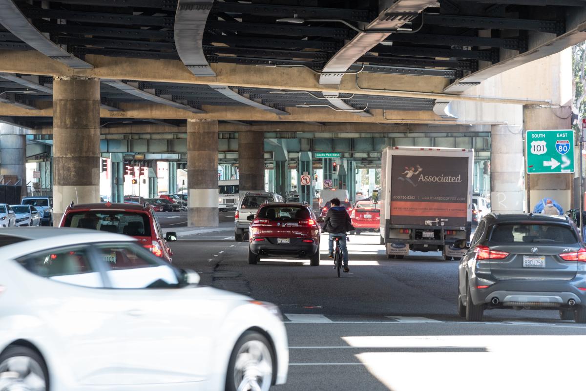 Photo of a person biking in mixed traffic on 13th Street