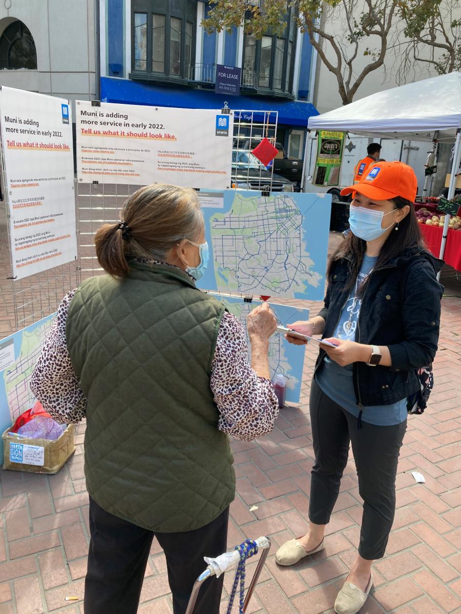 Photo of an SFMTA staffer talking to a customer