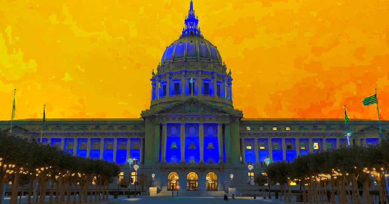Artistic image of City Hall bathed in blue light in front of an orange-yellow sky
