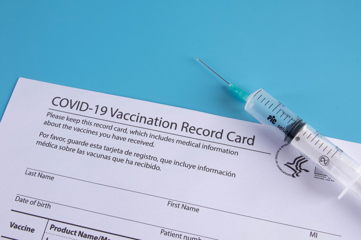 Covid Card and syringe stock photo