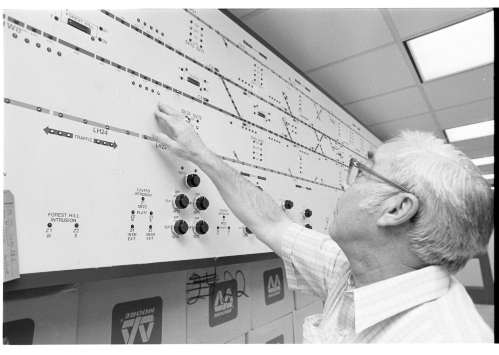 person pointing at map of subway system with lights