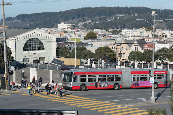 Photo of Presidio Middle school students in crosswalk while bus is stopped nearby