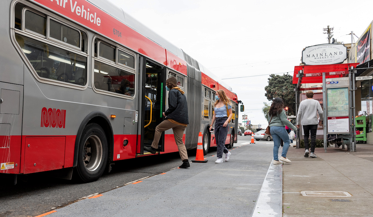 Photo of new temporary bus bulb on Geary Boulevard at 20th Avenue that allows buses to stop without pulling to the curb.