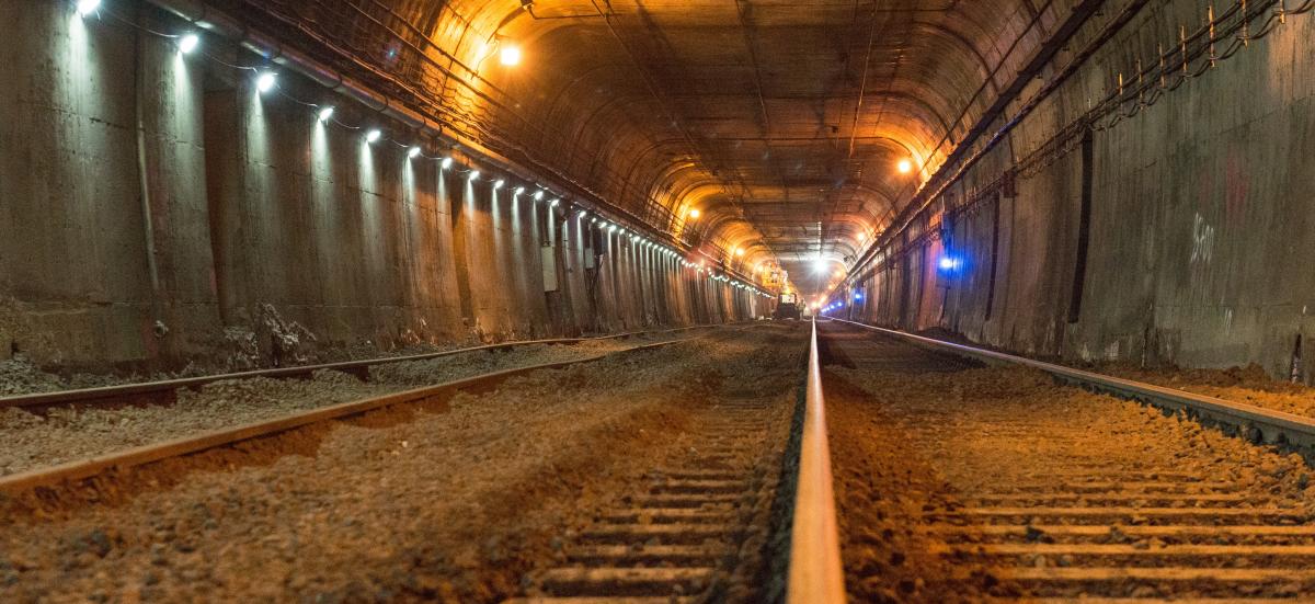 Photo of rails in subway tunnel with construction vehicle