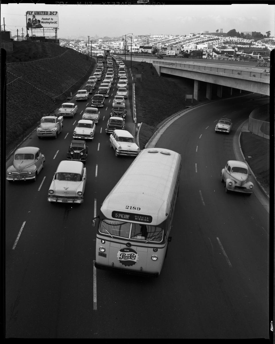 A Muni 15 3rd & Kearny bus makes a lane change on San Bruno & Harkness avenues in this 1957 photo.