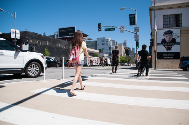 People using pedestrian safety zone on 8th Street that creates a shorter and safer crosswalk 