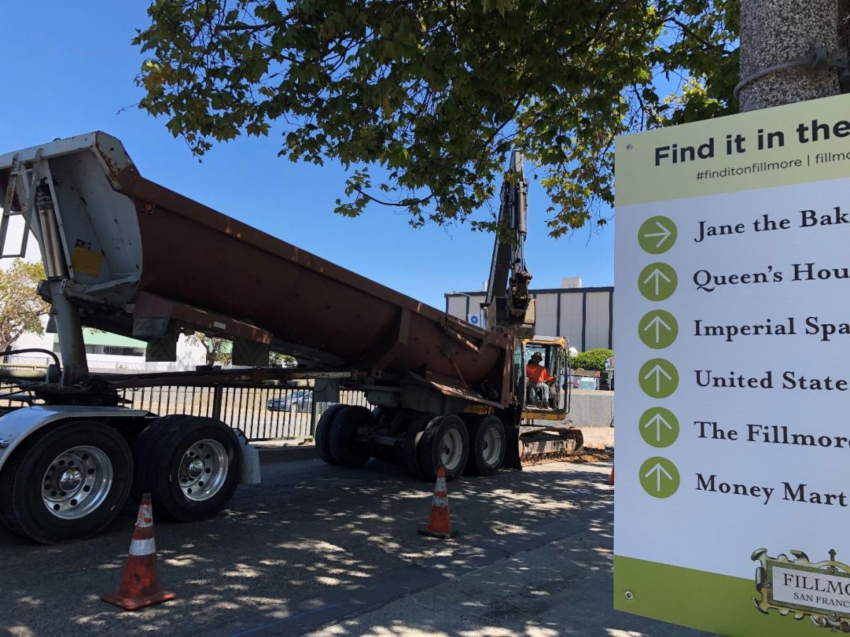 Photo of wayfinding signage next to Construction Crews working in the Fillmore