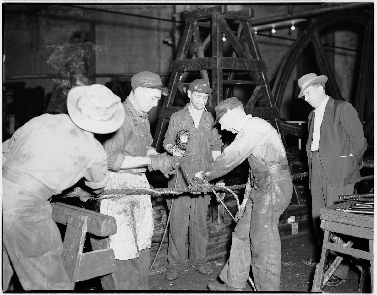 Four workers splicing a cable