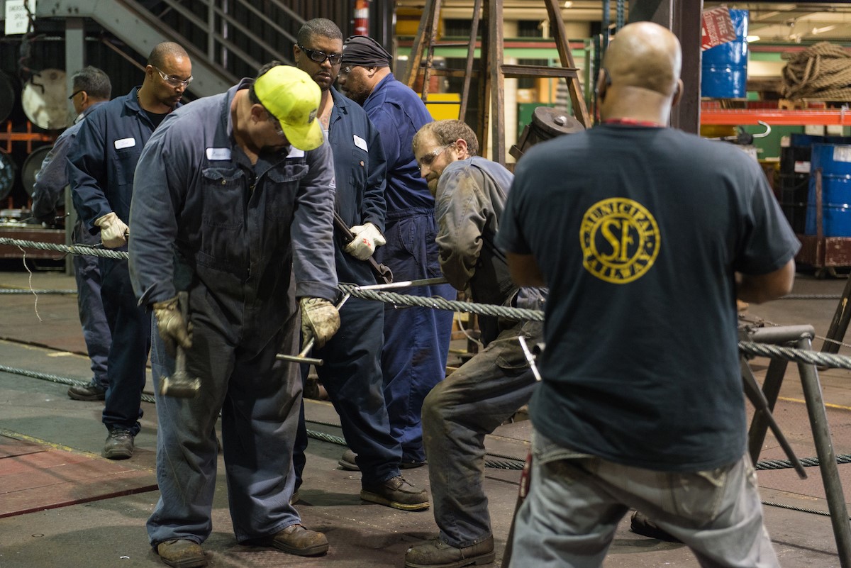 Workers splicing a cable