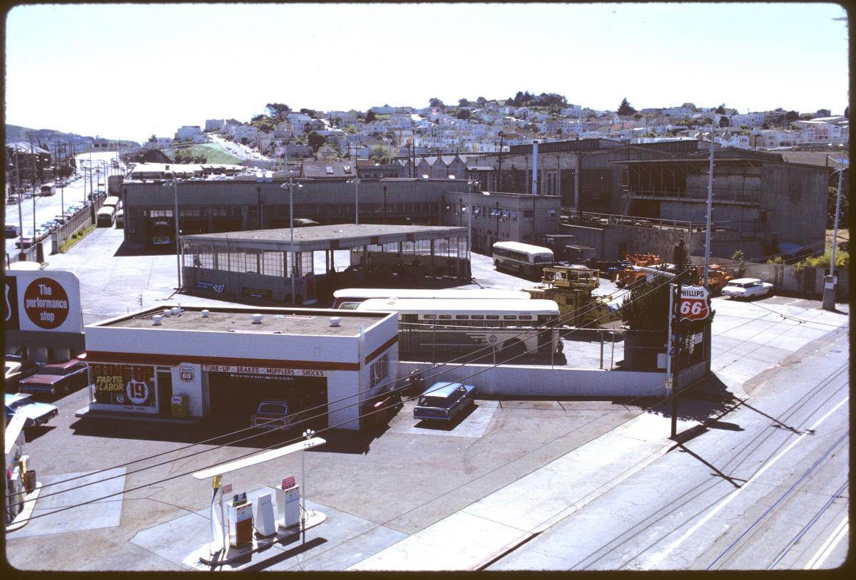 Looking southwest from San Jose and Ocean Avenues, this view shows Muni’s Ocean Division in 1972. At the left is a service station, center the fueling and shop buildings and at right are the Elkton Shops.