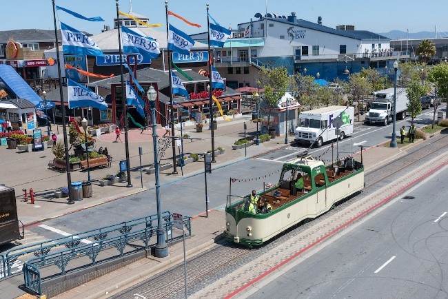 Photo of Pier 39 with historic "boat car" streetcar