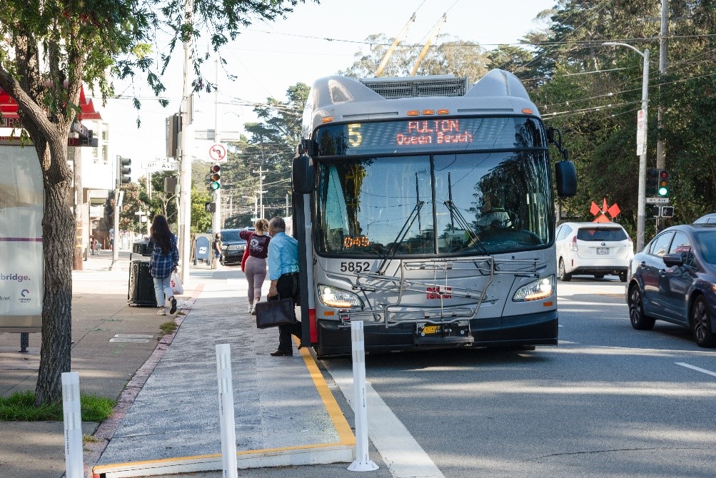 Photo of a 5 Fulton bus boarding passengers at a temporary transit bulb at 8th Avenue and Fulton, 