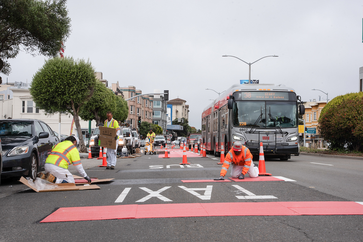 Photo of crew finishing red striping of Geary transit lane