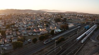 Photo of Capitol Corridor train and BART train travelling in East Bay