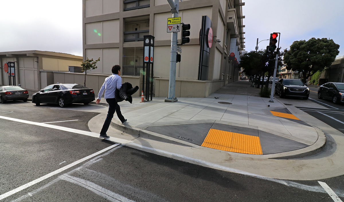 Photo: Pedestrian crossing street. Crossing distances are shorter at Geary and Laguna since new pedestrian bulbs were installed.  