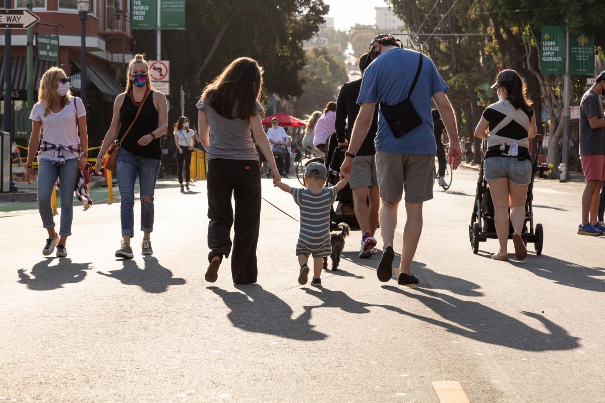 Images of pedestrians and people on bicycles enjoying a car free street