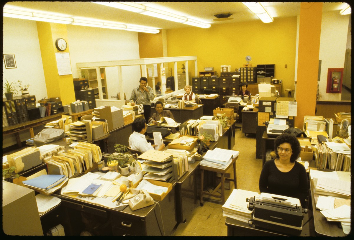 Typewriters, paperwork, and file cabinets abound in this view inside one of the offices at Presidio Division in the late 1970s