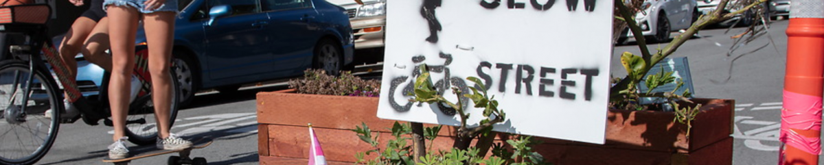 Image of a cyclist and skateboarder utilizing the Page slow street