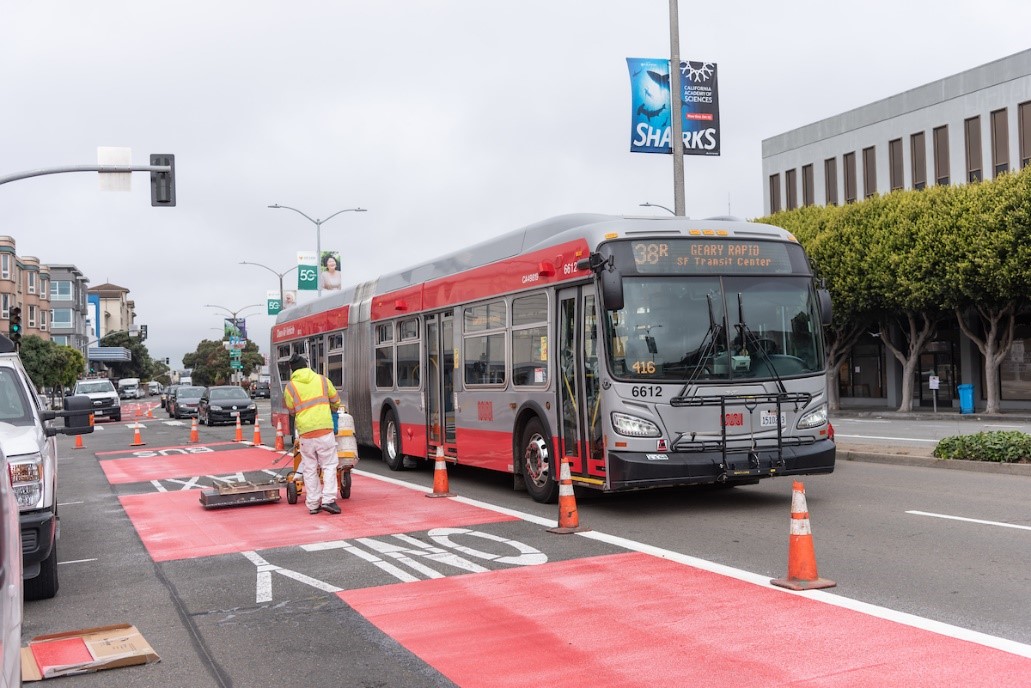 SFMTA paint shop crews install new red transit lanes on Geary Boulevard
