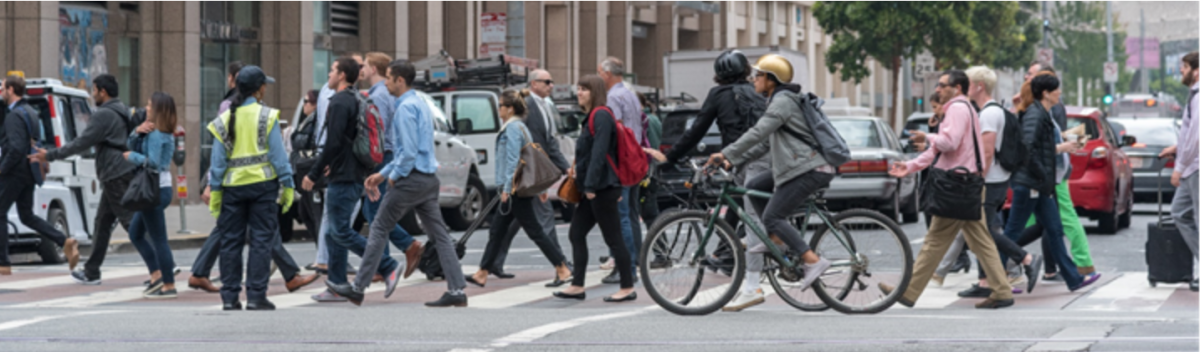 Pedestrians walk in a crosswalk on Market Street