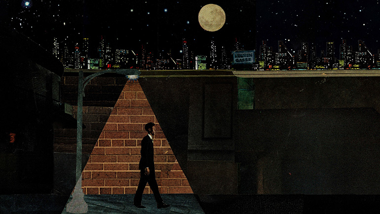 A suited male walks past a brick wall under a street lamp, surrounded by darkness, with the downtown skyline, moon and stars in the background.