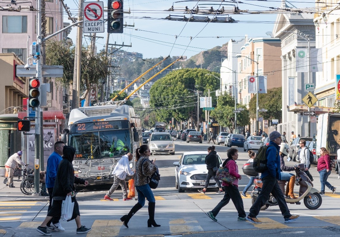 Pedestrians crossing the intersection at 16th and Mission streets.