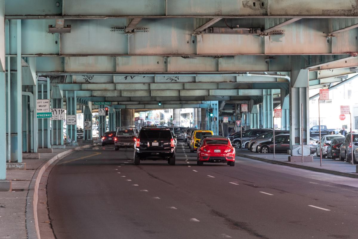 Conditions on 13th Street before project implementation. Cars are shown on the roadway under the freeway overpass.