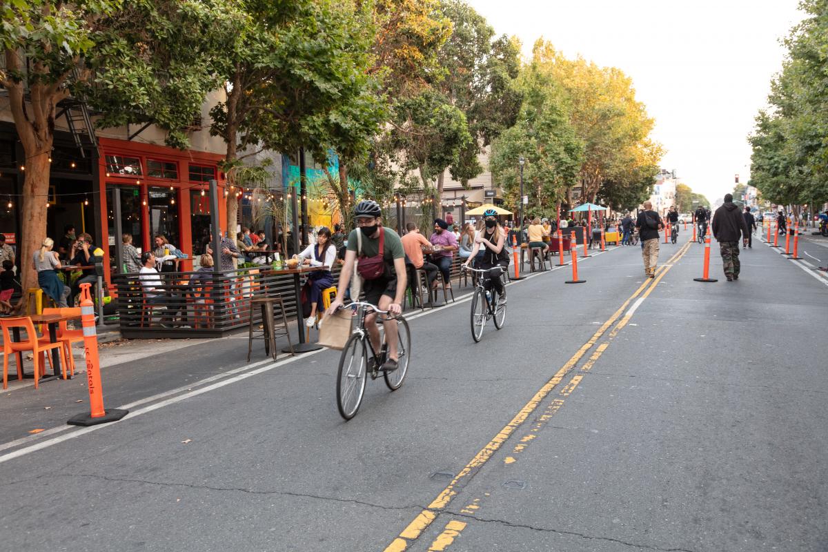 People biking down Valencia Street in the Mission