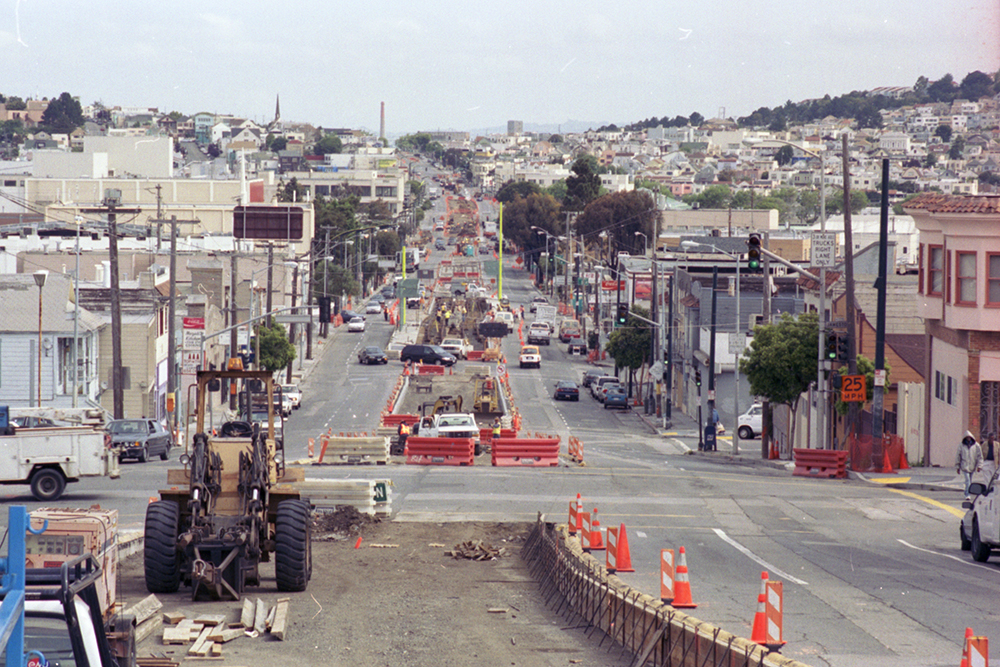 A long perspective view of a corridor showing the city's neighborhood skyline 