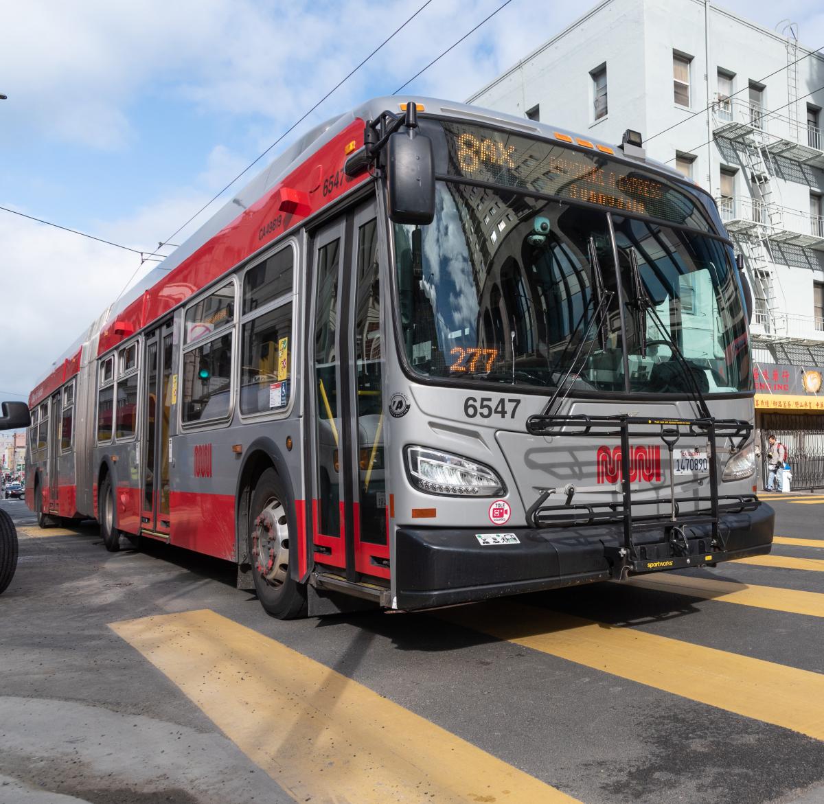 Photo showing an 8AX Bayshore Express articulated Muni bus on the road.