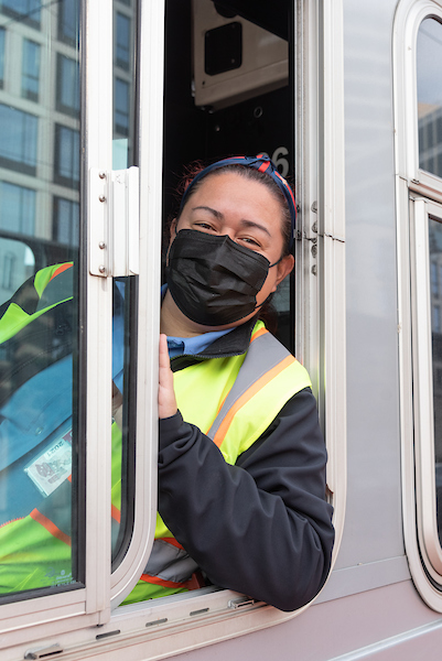 Smiling operator from the window of a bus