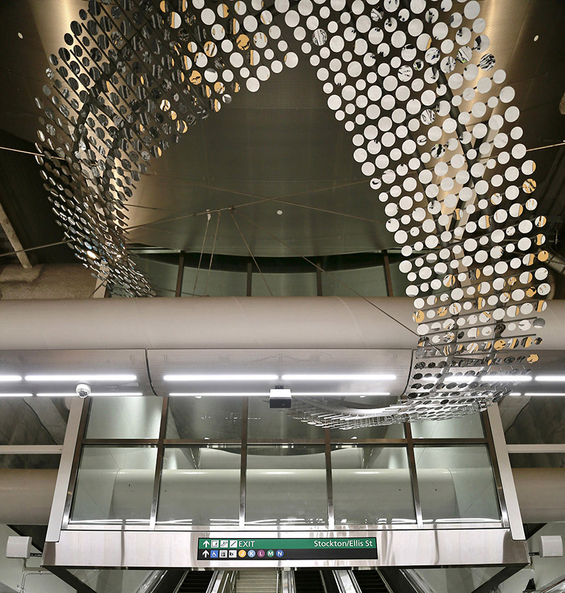 Artwork comprised of thousands of mirrored disks linked together to form a 250-foot long stainless-steel sculpture suspended above the platform level.