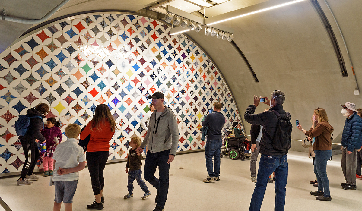 Photo of Clare Rojas's artwork titled "A Sense of Community" inside the Chinatown-Rose Pak Station