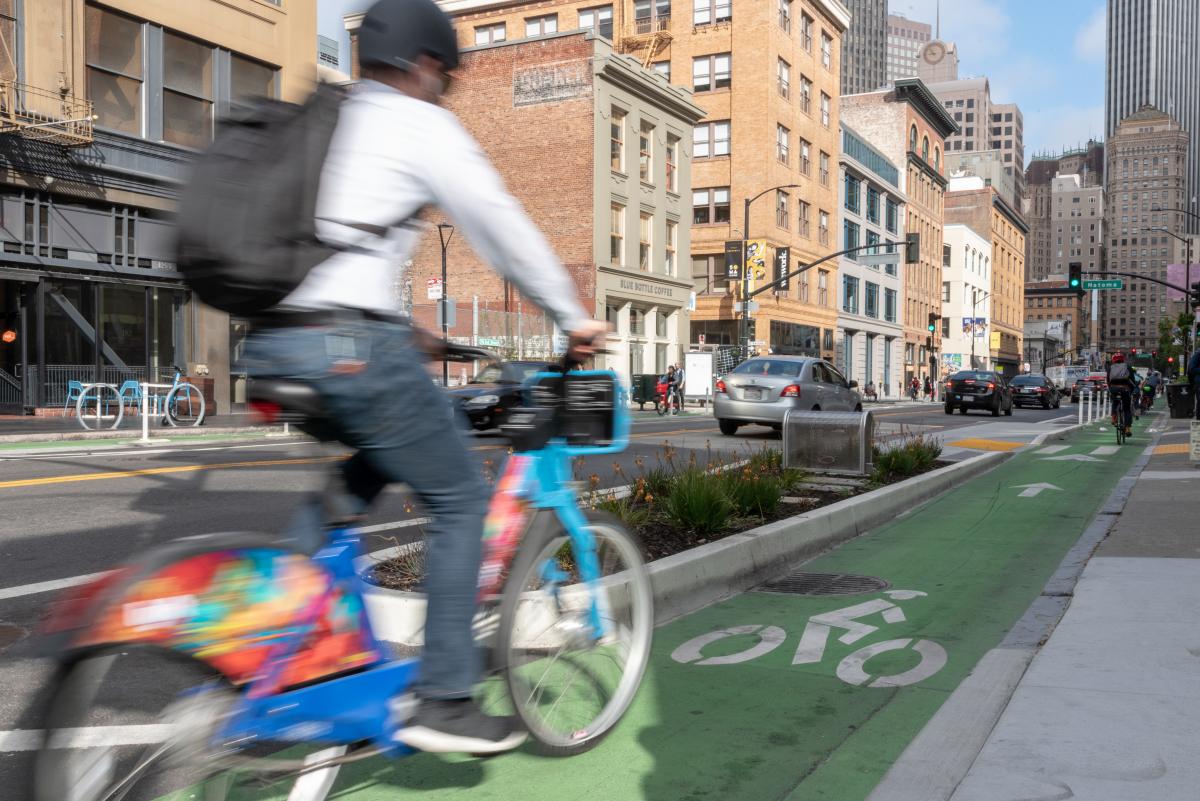 Image of a bikeshare rider using a designated bike lane on city streets 