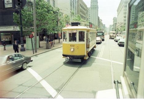 Vintage photo of Streetcar 122 from Portugal on city streets.