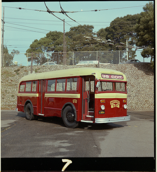 Muni bus 062 in red and yellow paint job with “39 Coit” route sign.