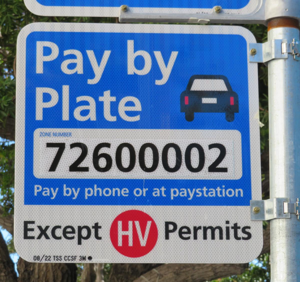 sign that says Pay by Plate (pay by phone or at paystation) Except HV Permits